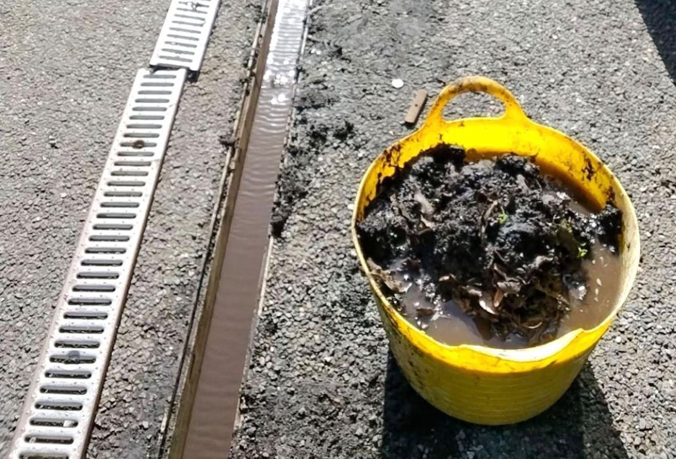 Leaves and silt removed from a blocked channel drain